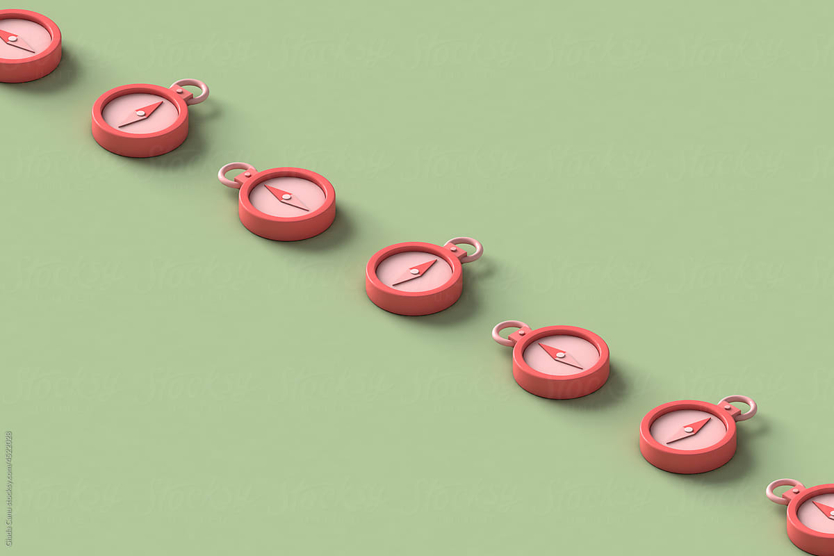 a row of pink compasses with copy space