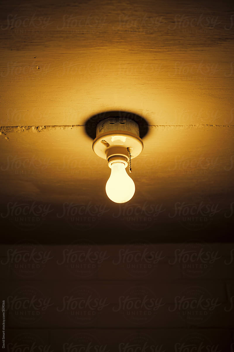 Bare incandescent light bulb in industrial building