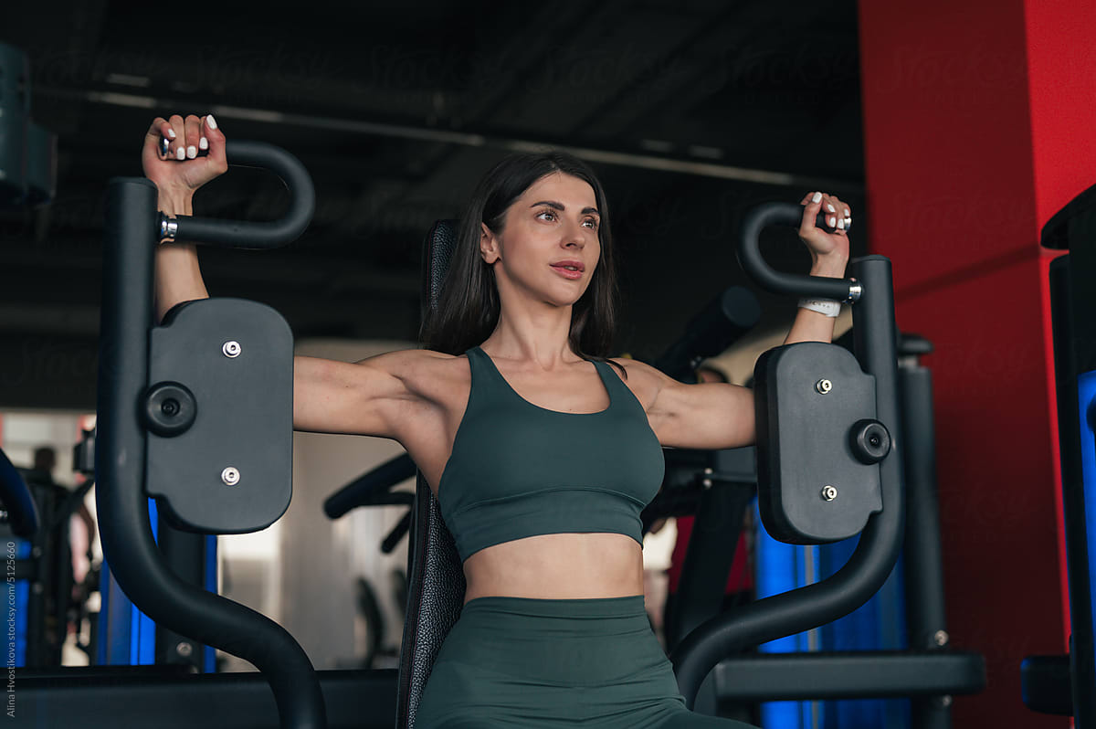 Woman exercising on chest fly machine