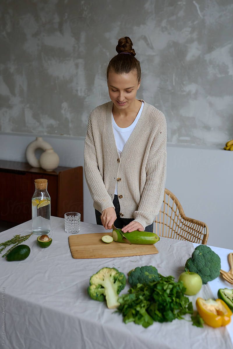 a vegetarian cooks herself healthy delicious food from vegetables