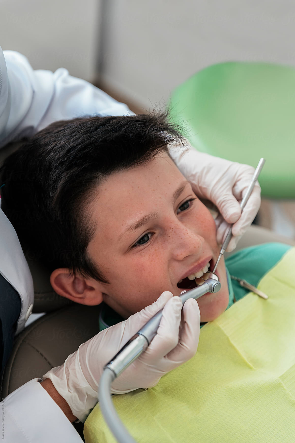 Dentist during a dental intervention with a patient.