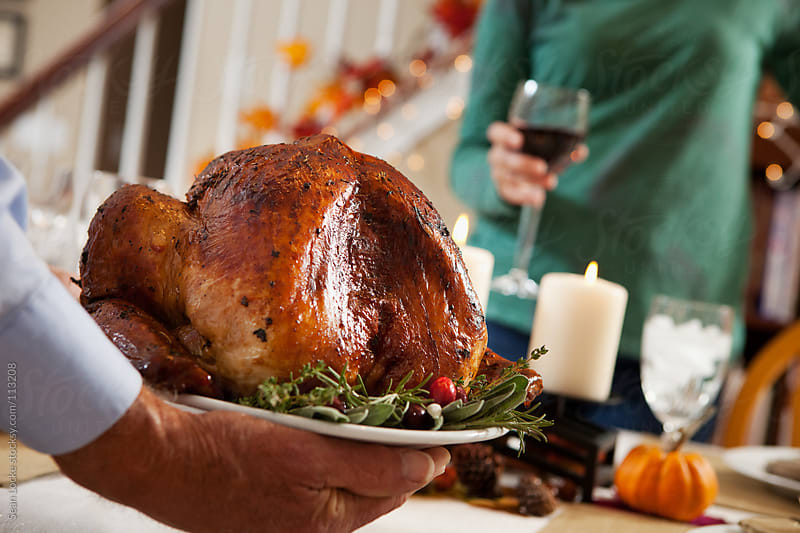 Thanksgiving: Man Carries Turkey To Table by Sean Locke - Stocksy United