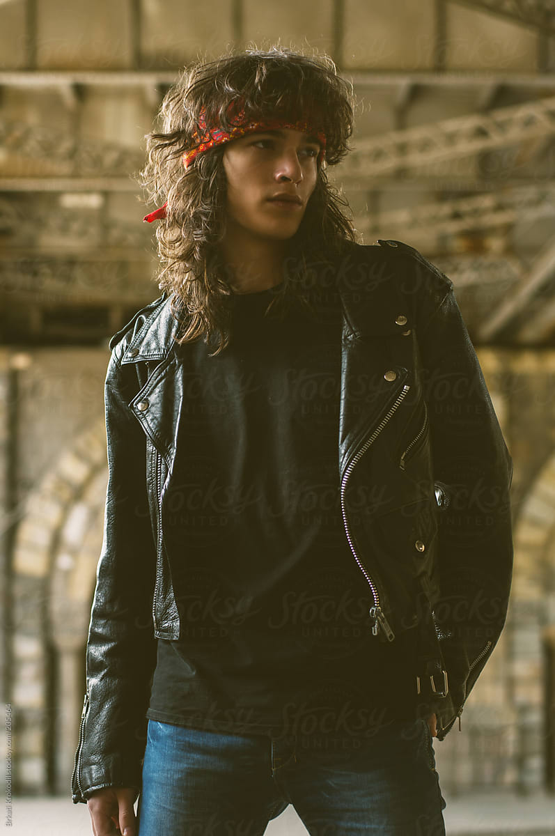 Young Man With Long Curly Hair Wearing Leather Jacket