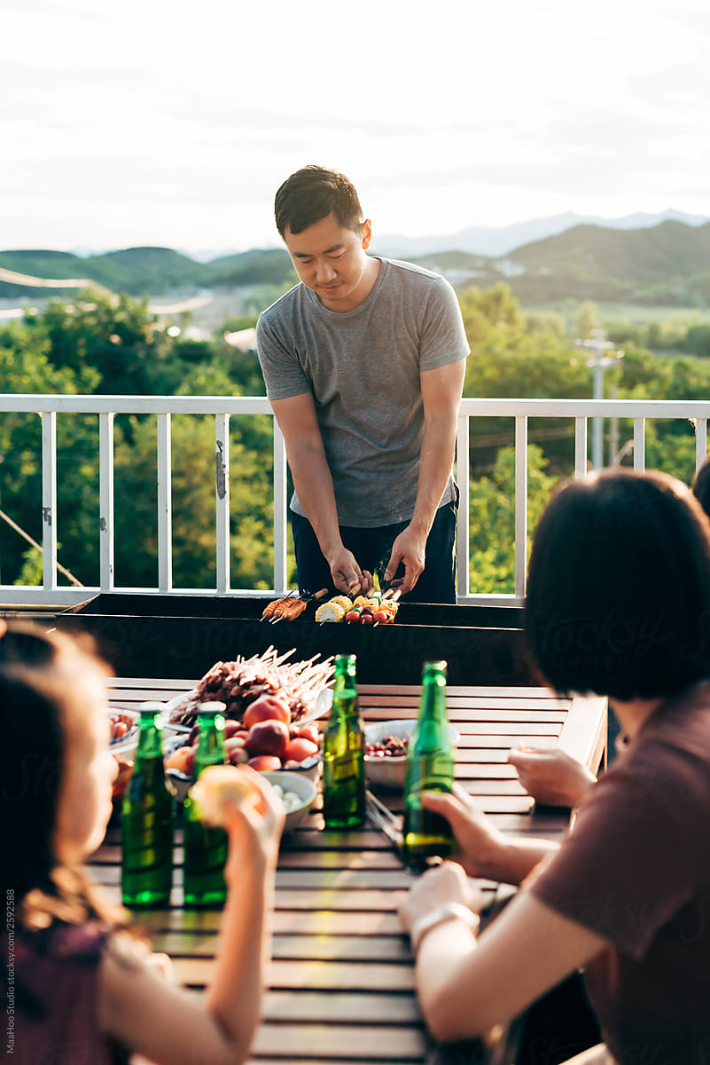friends barbecuing on rooftop