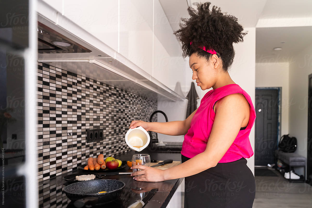 Pregnant Woman Preparing Juice At Home Kitchen