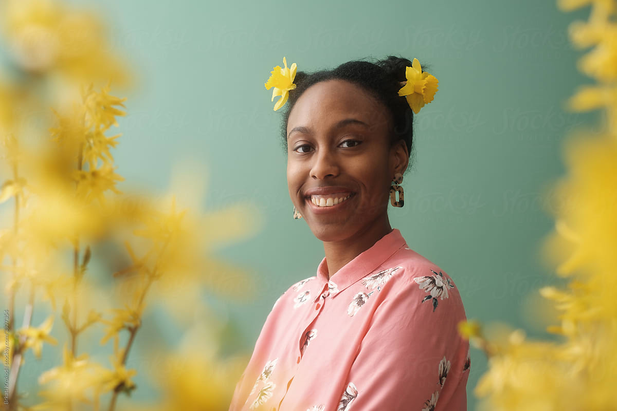 Smiling Black Woman With Yellow Flowers