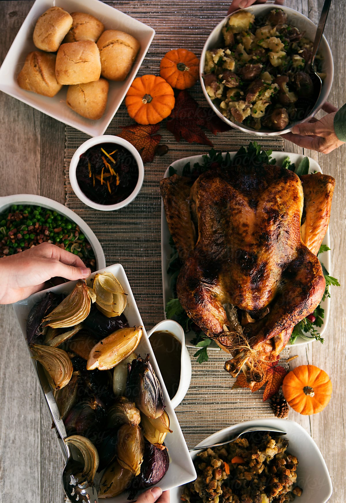 Thanksgiving: Putting Side Dishes On Table With Turkey