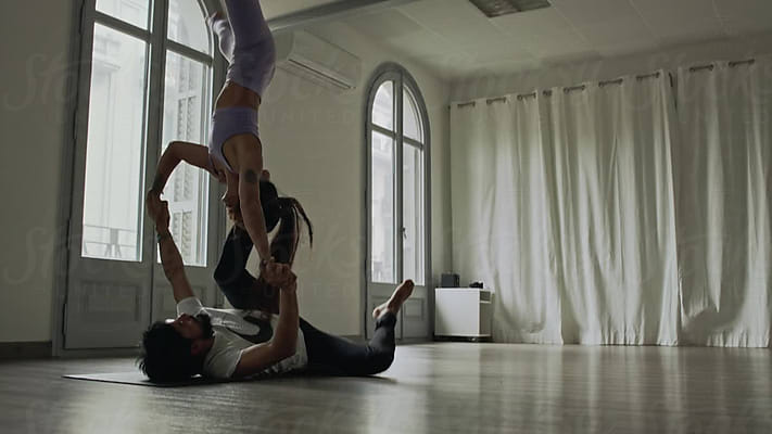 Slim Woman Practicing Yoga On Mat by Stocksy Contributor Milles Studio