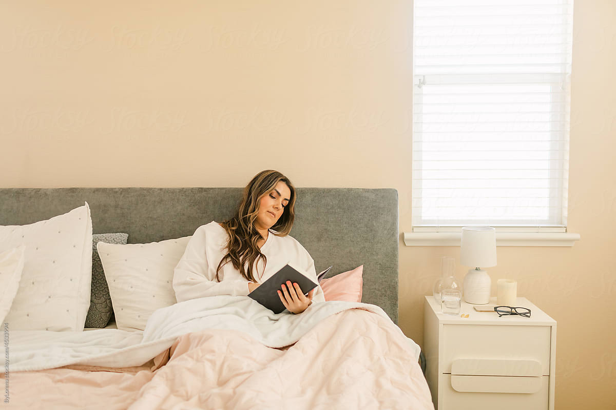 Beautiful woman reading in bedroom