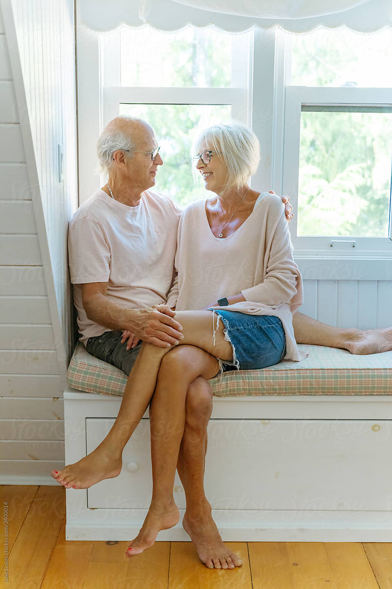 Happy elderly couple sitting together