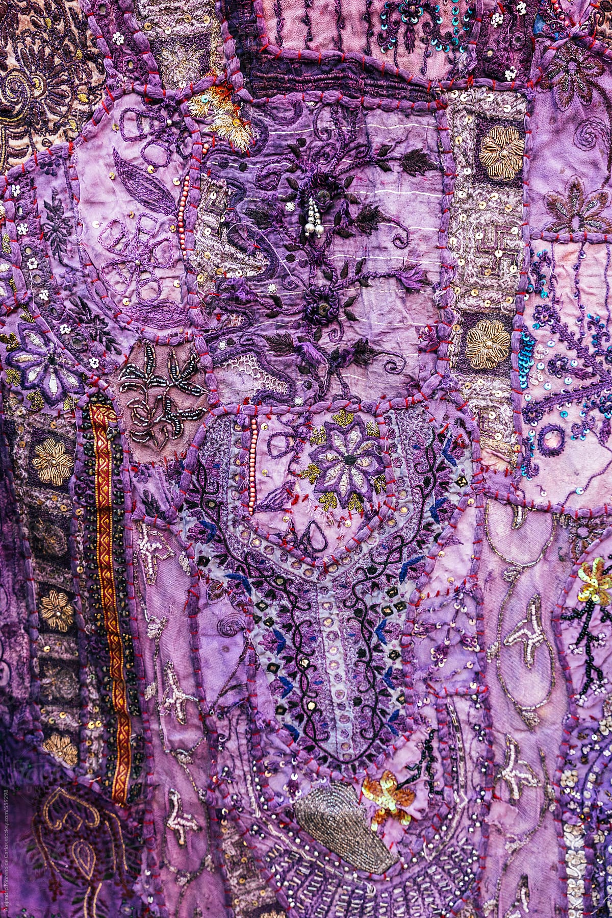 Decorative pattern on a purple traditional Indian piece of fabric. India texture