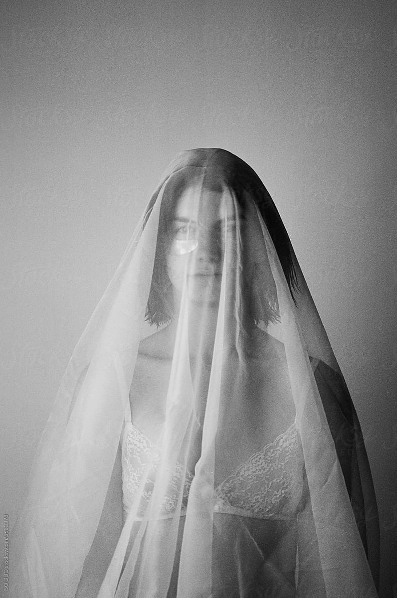Young woman covered with veil