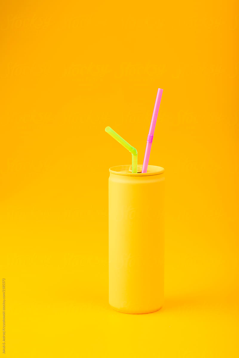 Yellow can with straws on yellow background