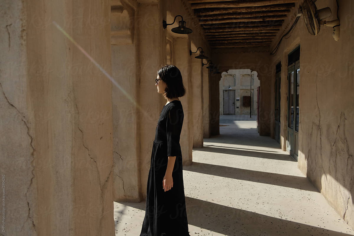 Woman in long black dress in old town of Dubai