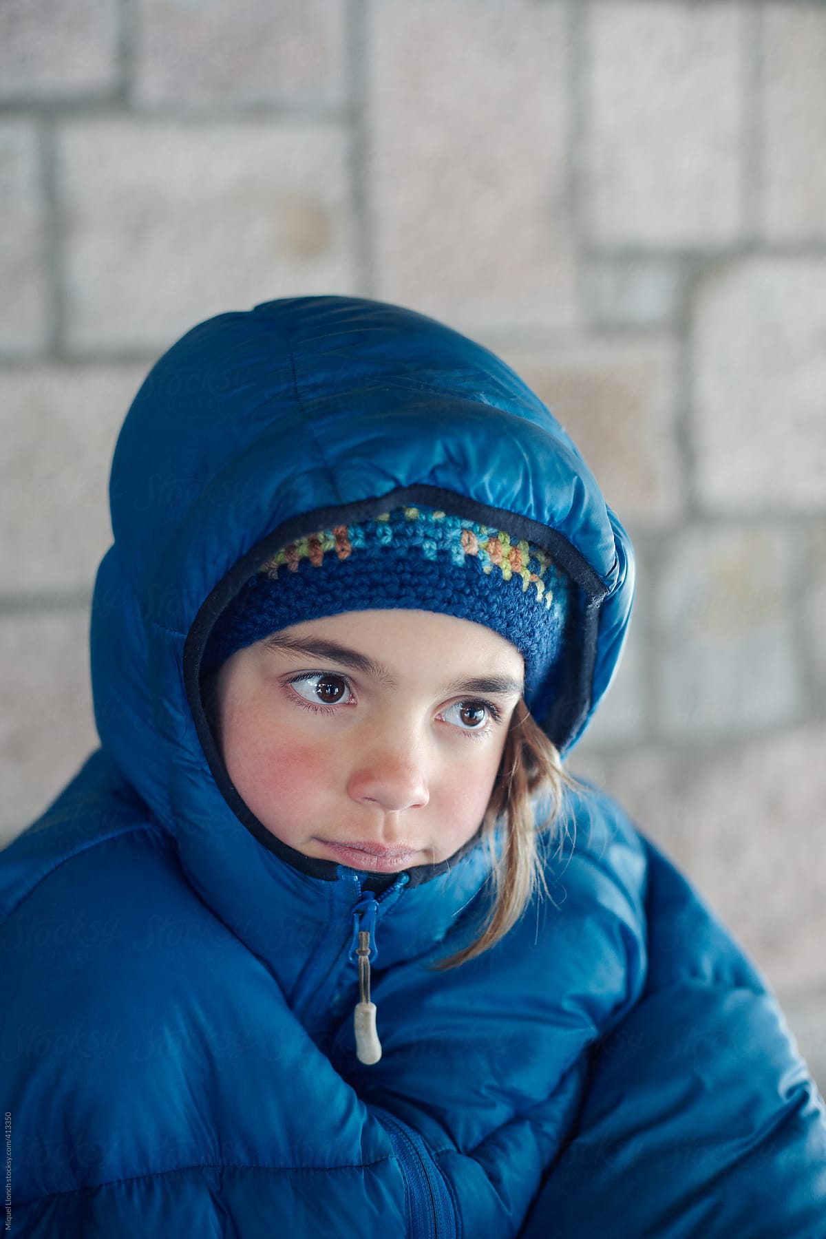 Young girl with down jacket in a cold winter day