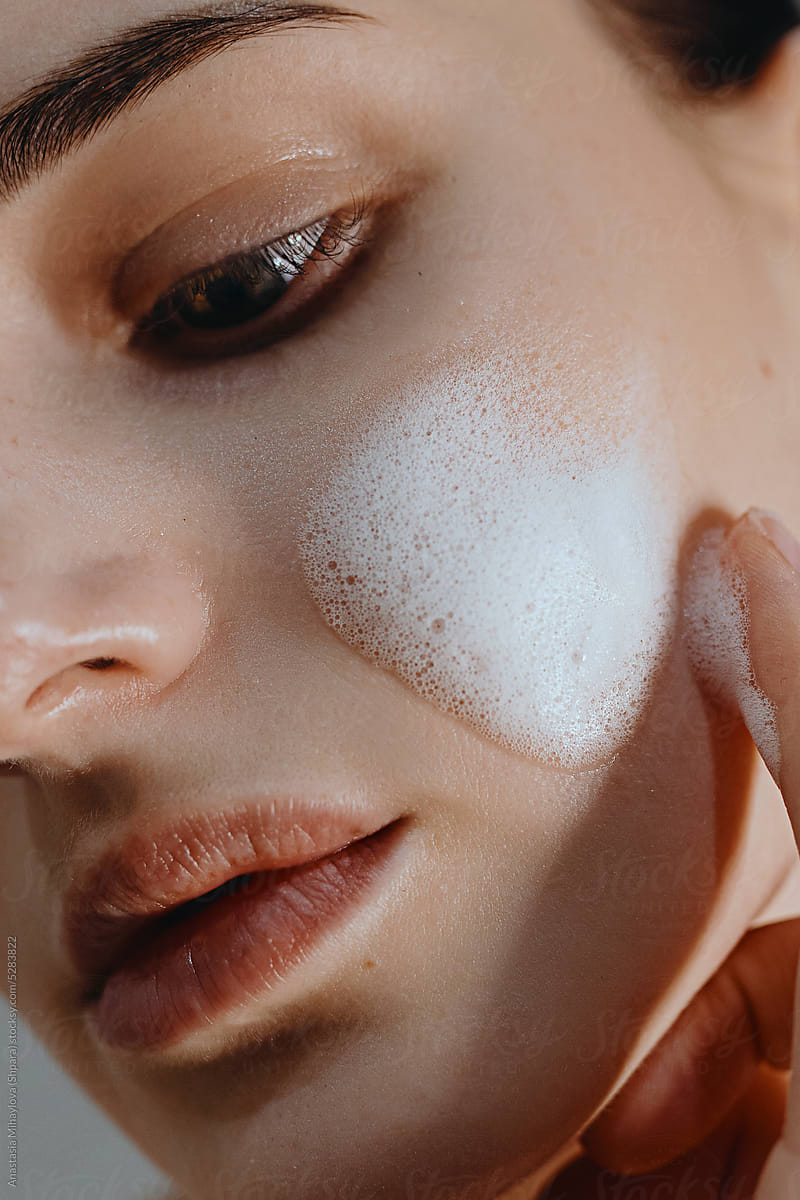 Close Up woman\'s portrait with face wash foam