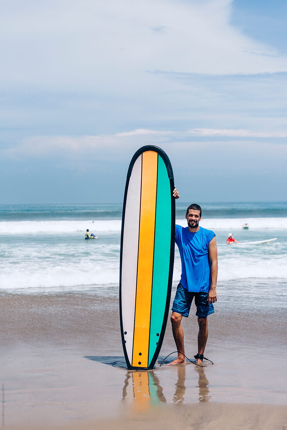 Man holding longboard at the surfing beach