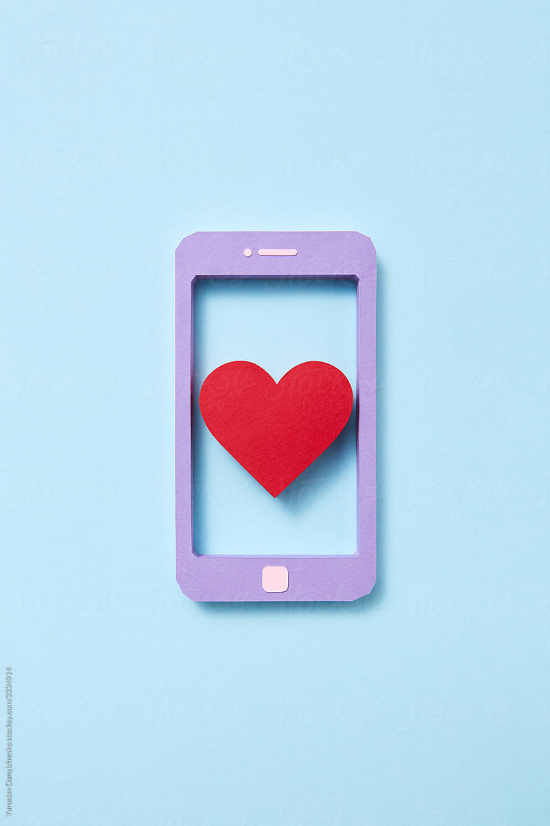 Handmade paper smartphone with red heart.