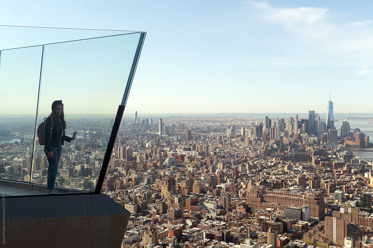 Woman overlooking expansive Manhattan skyline from The Edge