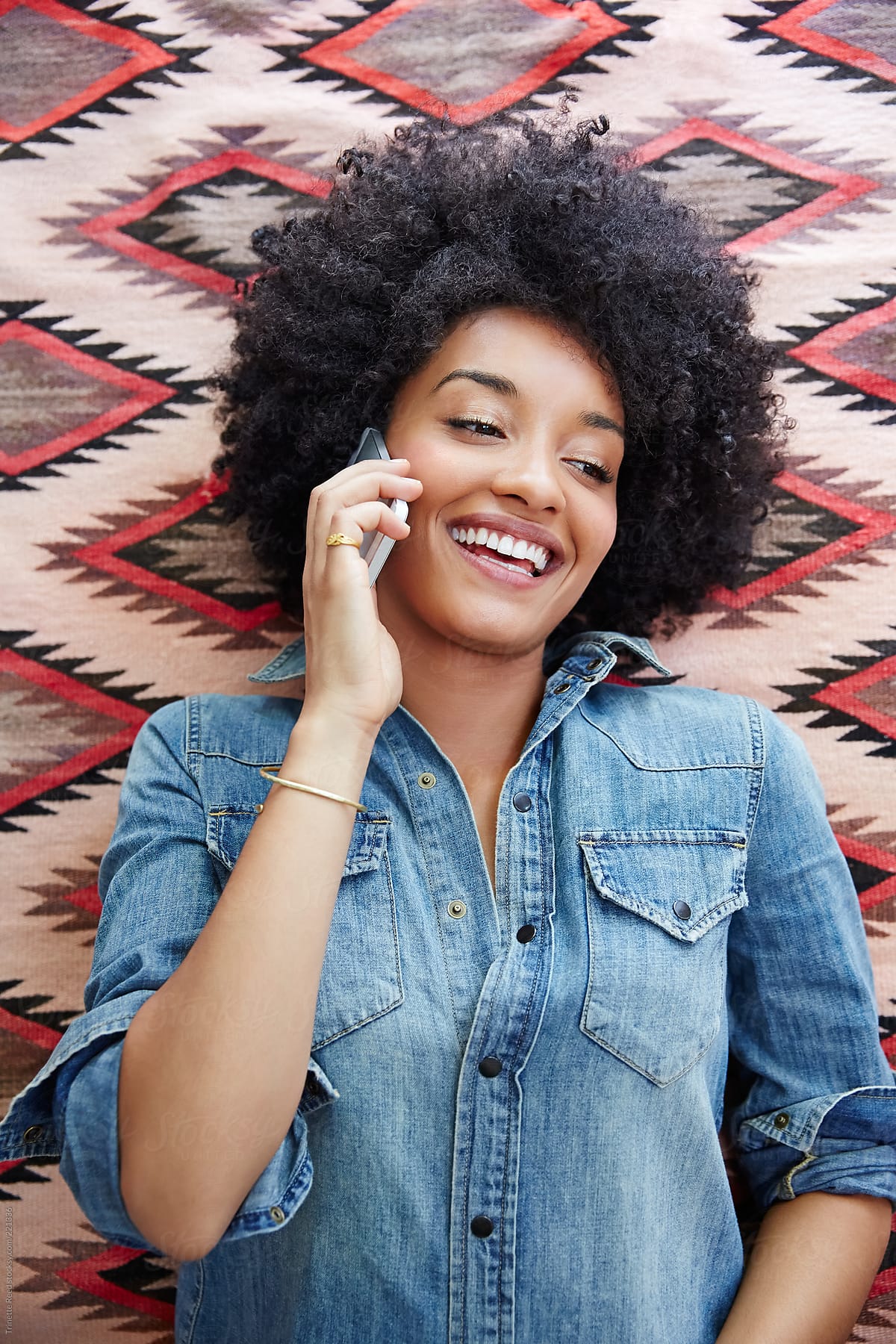 Happy African American woman talking on cell phone
