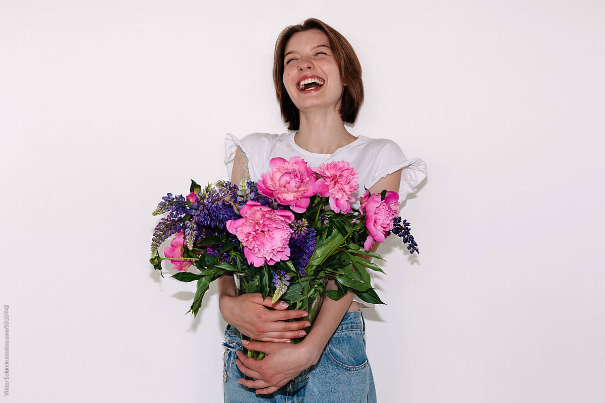 Happy woman with bouquet of flowers