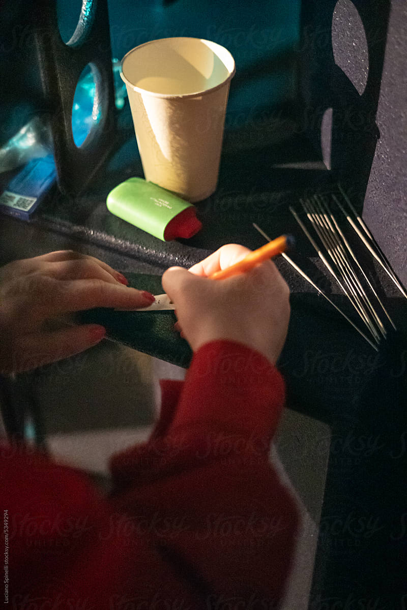 Woman writing new year wishes at underground party: Russian tradition