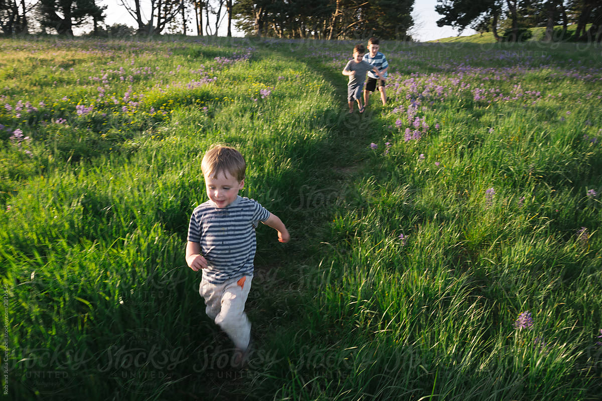 Running boys in grass