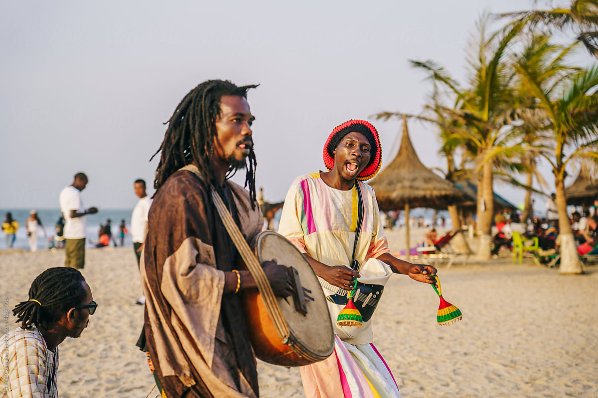 African group playing music on beach