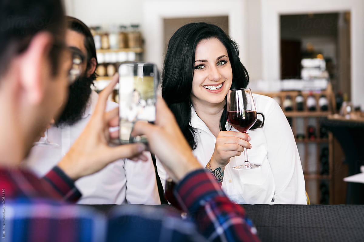 Wine: Man Takes Photo Of Friend Holding Wine Glass