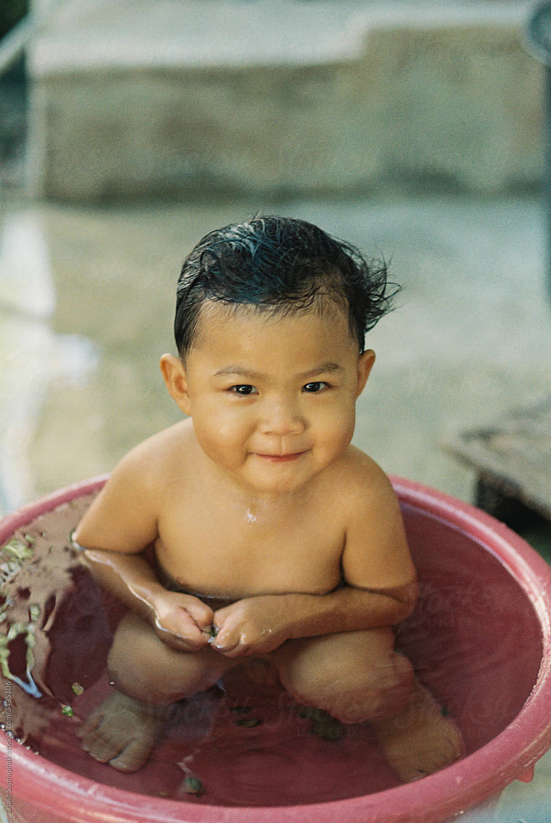 Asian children take a bath in the plastic tub