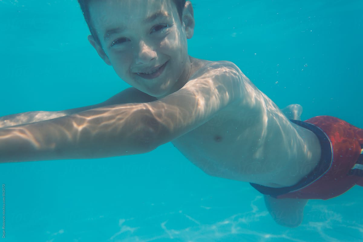 Boy smiling underwater.