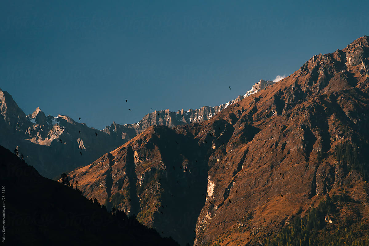 Nepalese landscape - mountain slopes and snowy peaks on the background