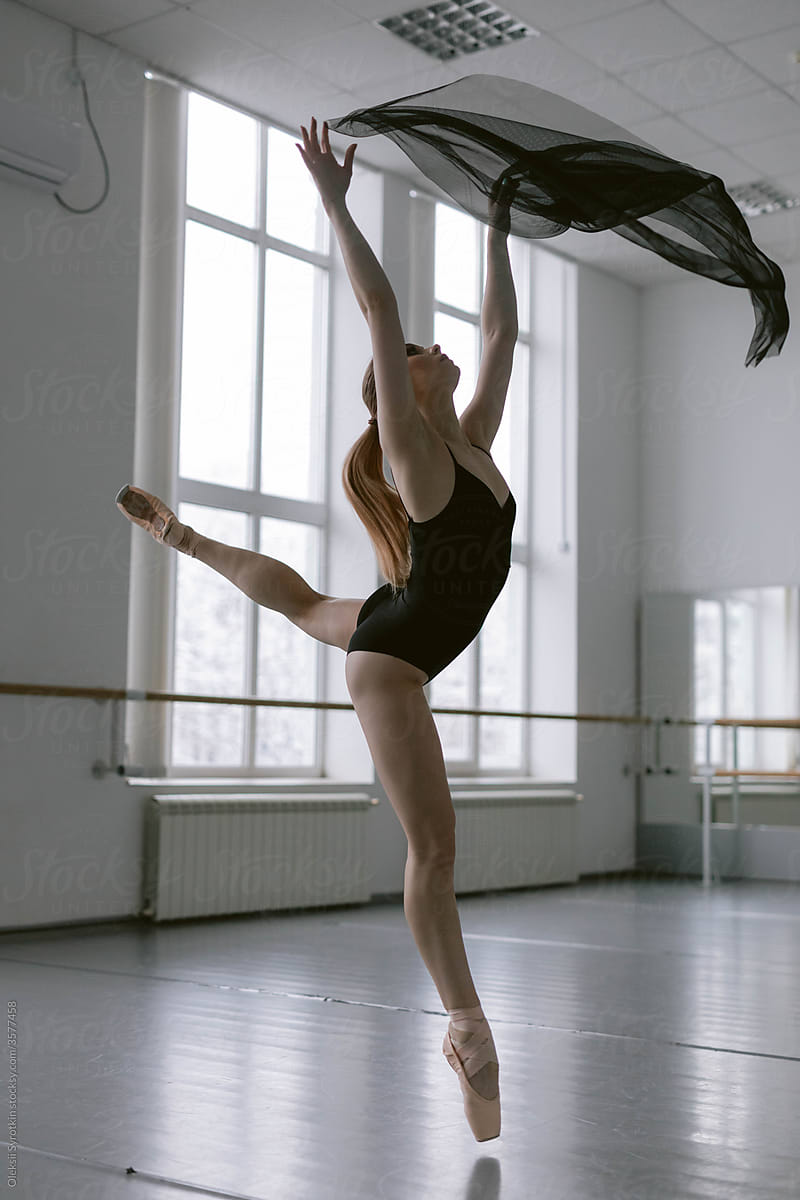 Ballet dancer training in empty studio