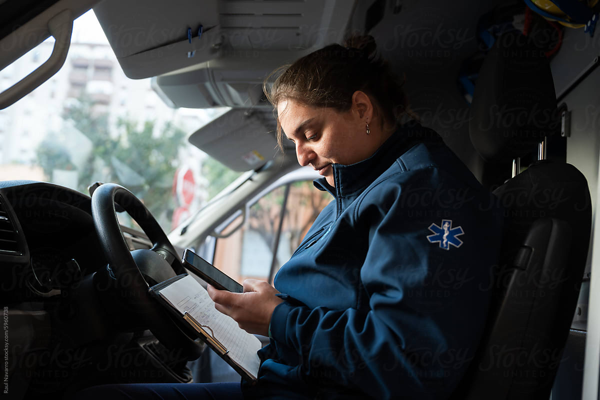 Female Paramedic Reviewing Medical Records