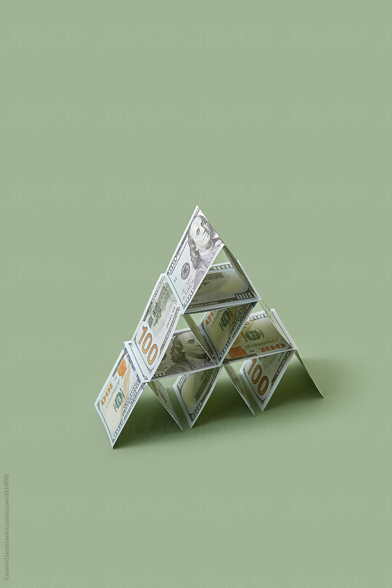 Folded dollar bills arranged as pyramid.