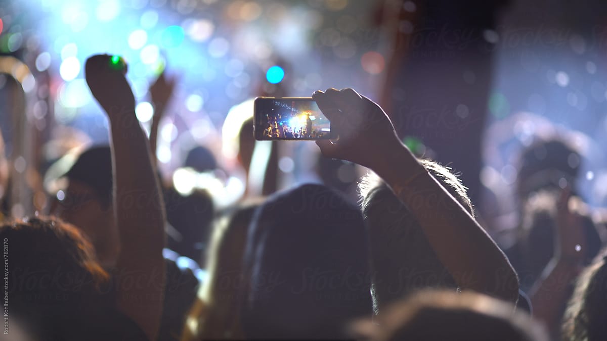 Making photo, video with cell phone at live music concert, festival