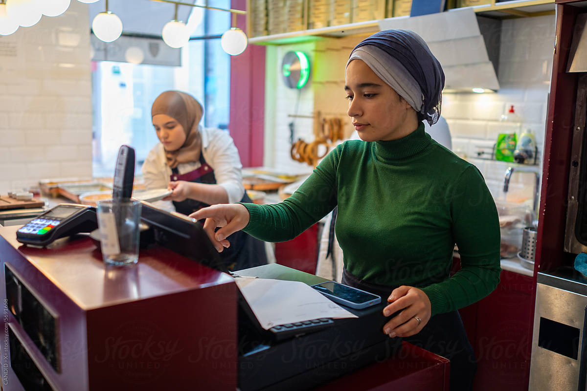 Muslim Cashier Printing the Receipt
