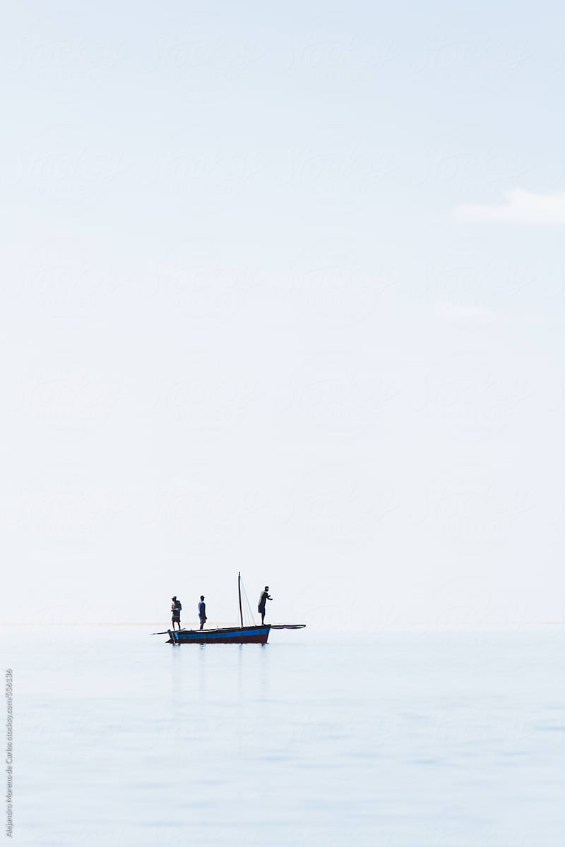 Fishermen silhouette on a traditional boat in the sea with copyspace. Vilanculos, Mozambique