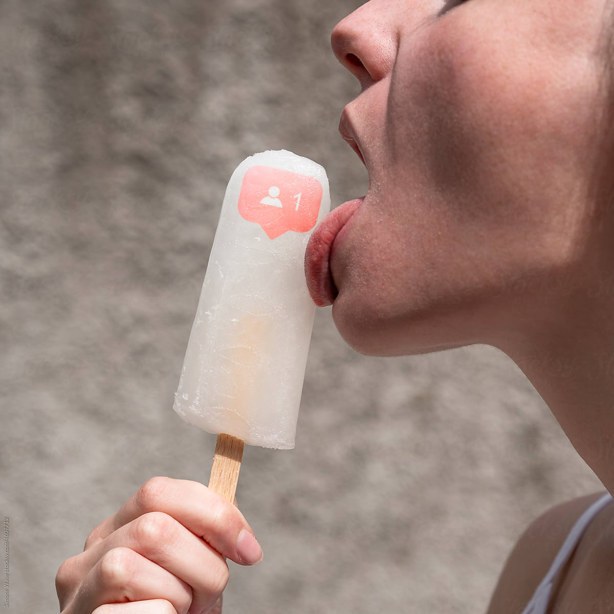 Woman licks ice lolly with followers icon