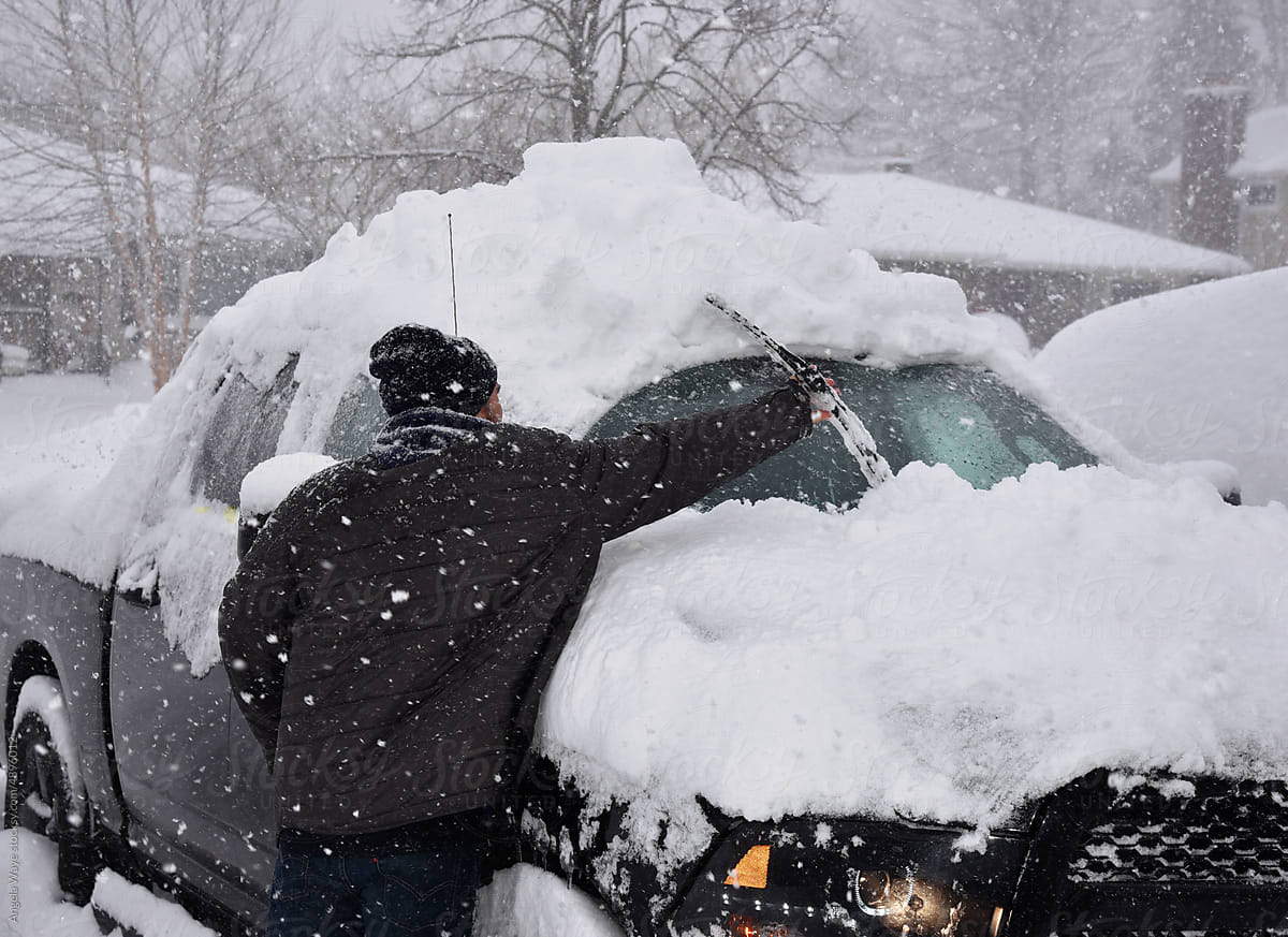 Car Covered with Snow During Snowstorm