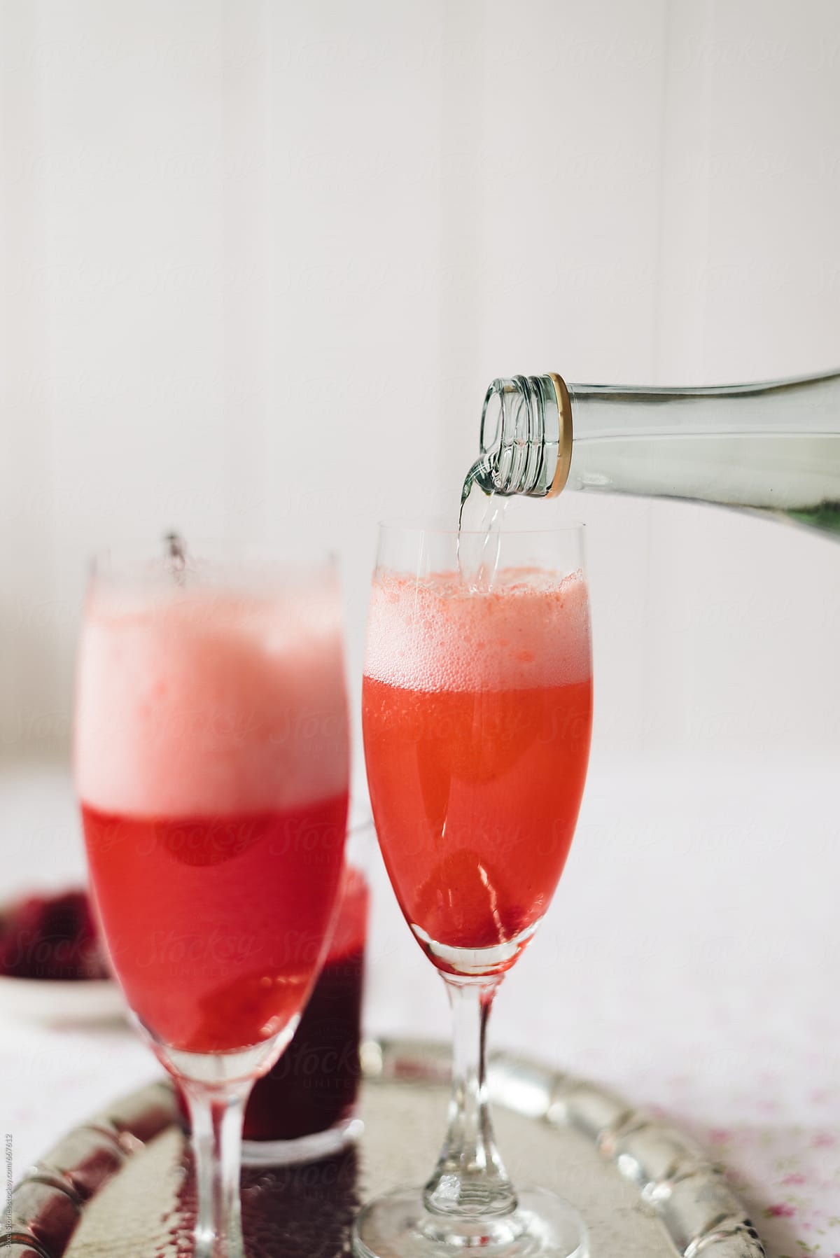 Making raspberry bellini prosecco cocktail