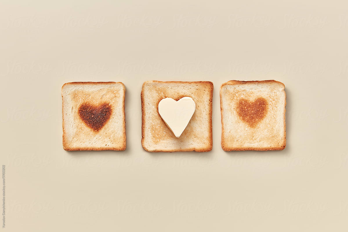 Three toasts with burnt hearts and one wth butter