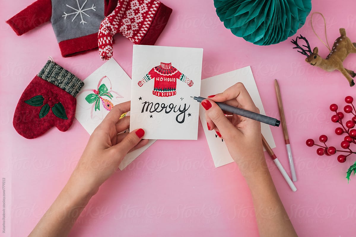 Woman Drawing Holiday Illustration on a Christmas Cards