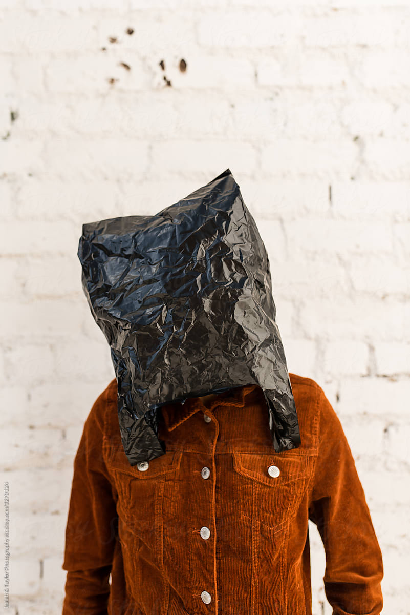 person with hiding under trash bag face mask