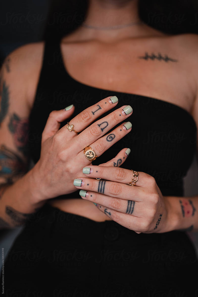 Woman\'s hands with tattoos and manicure