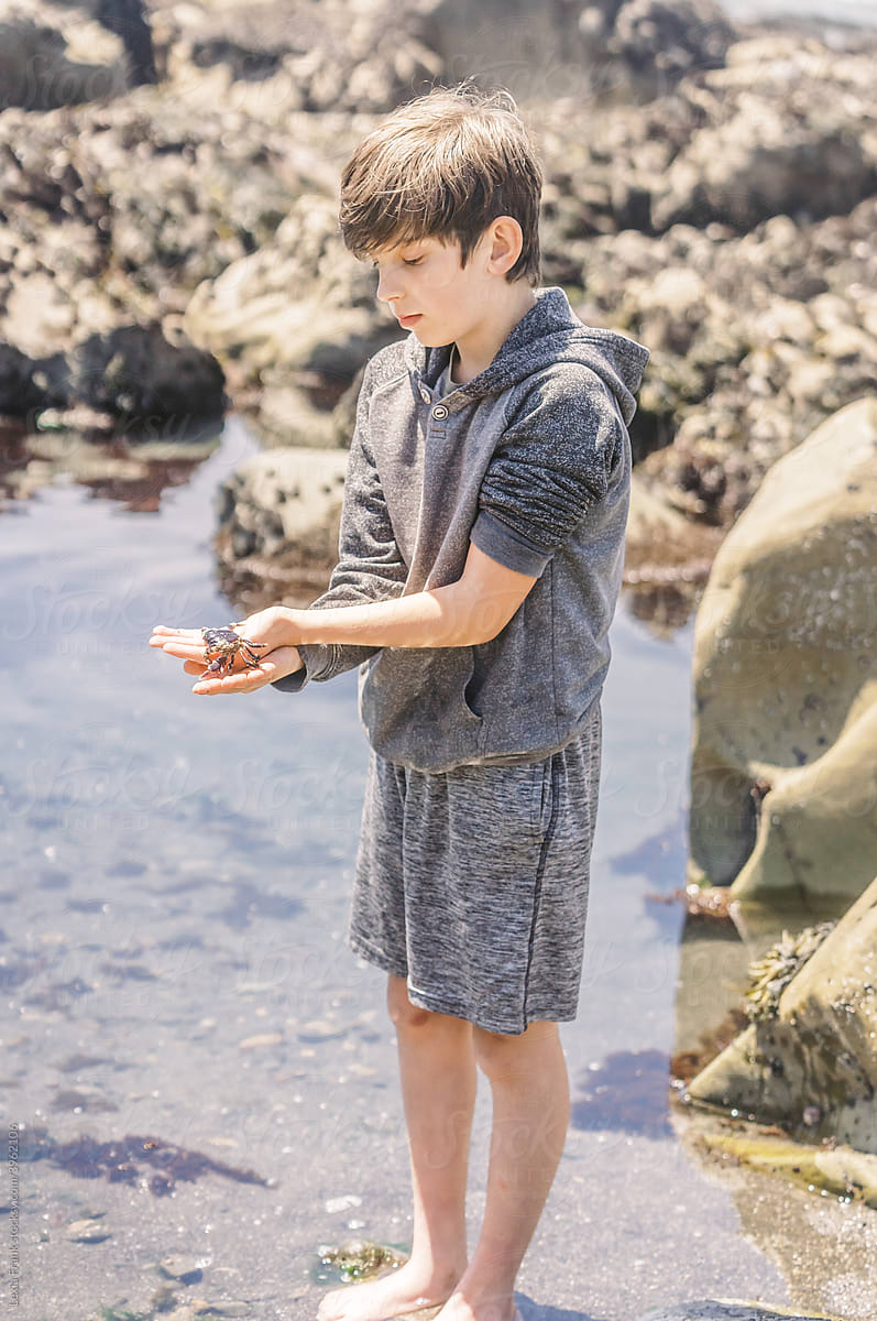young boy holds sea creature