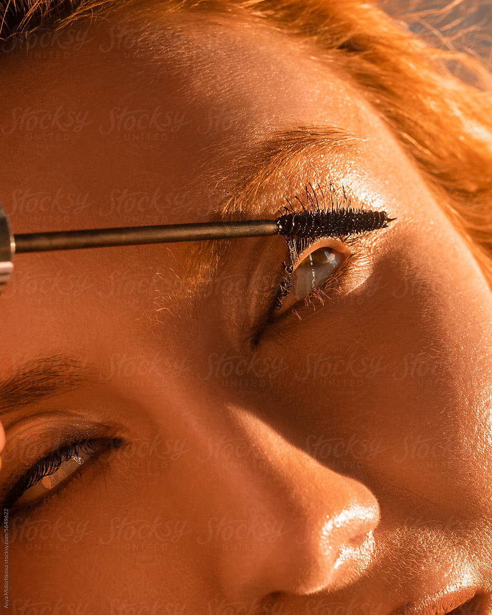 Close-up of applying mascara to eyelashes