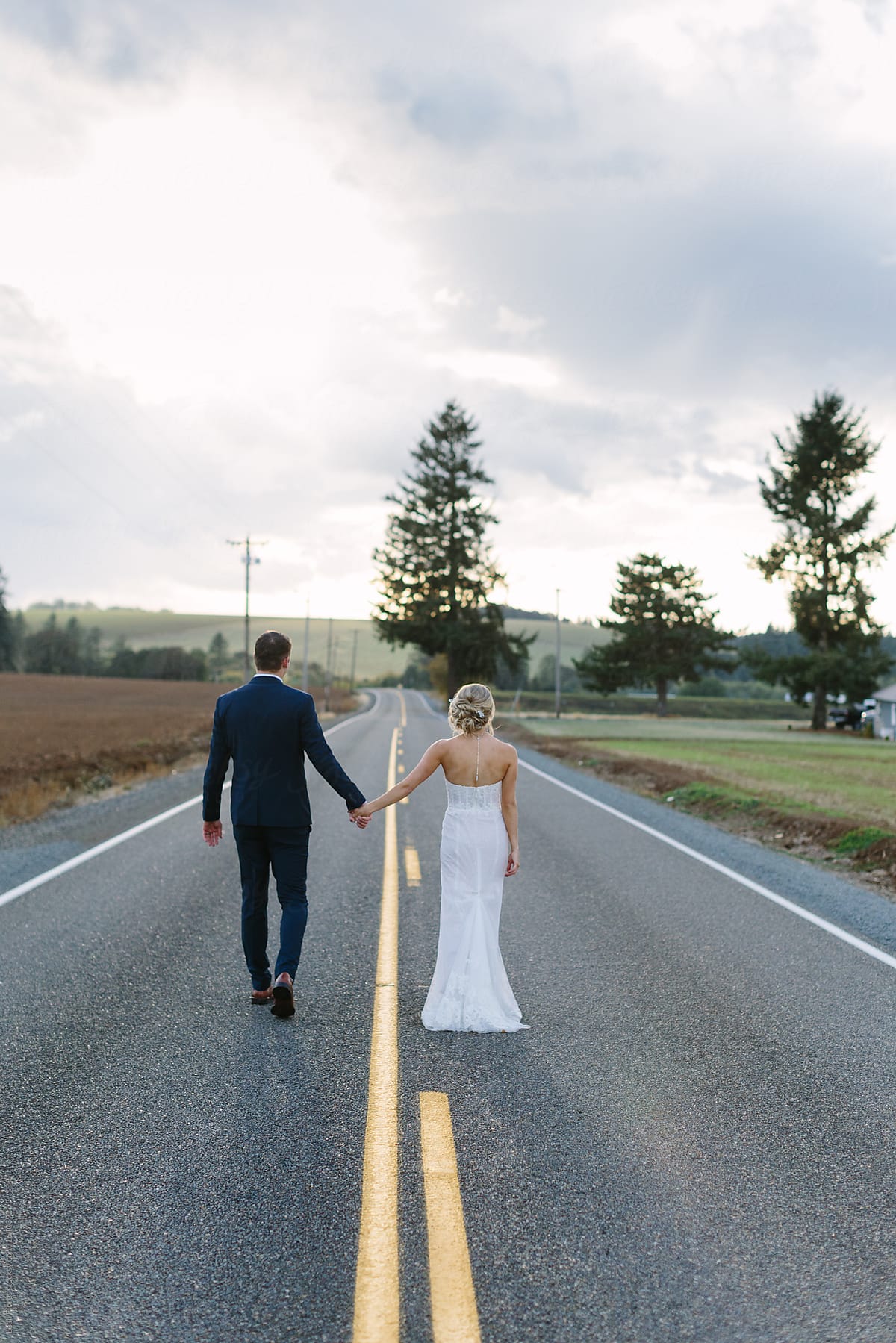 Bride and Groom Walking down Road