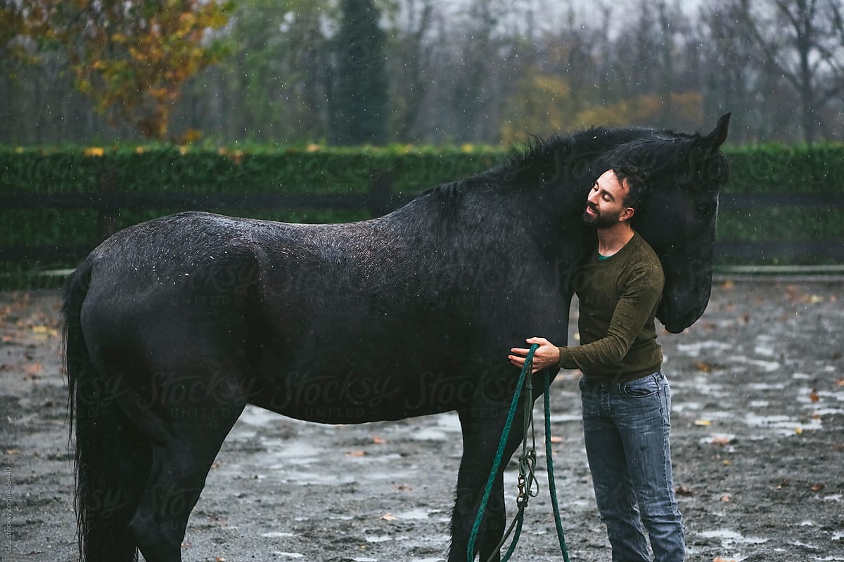 Man and horse enjoying the rain