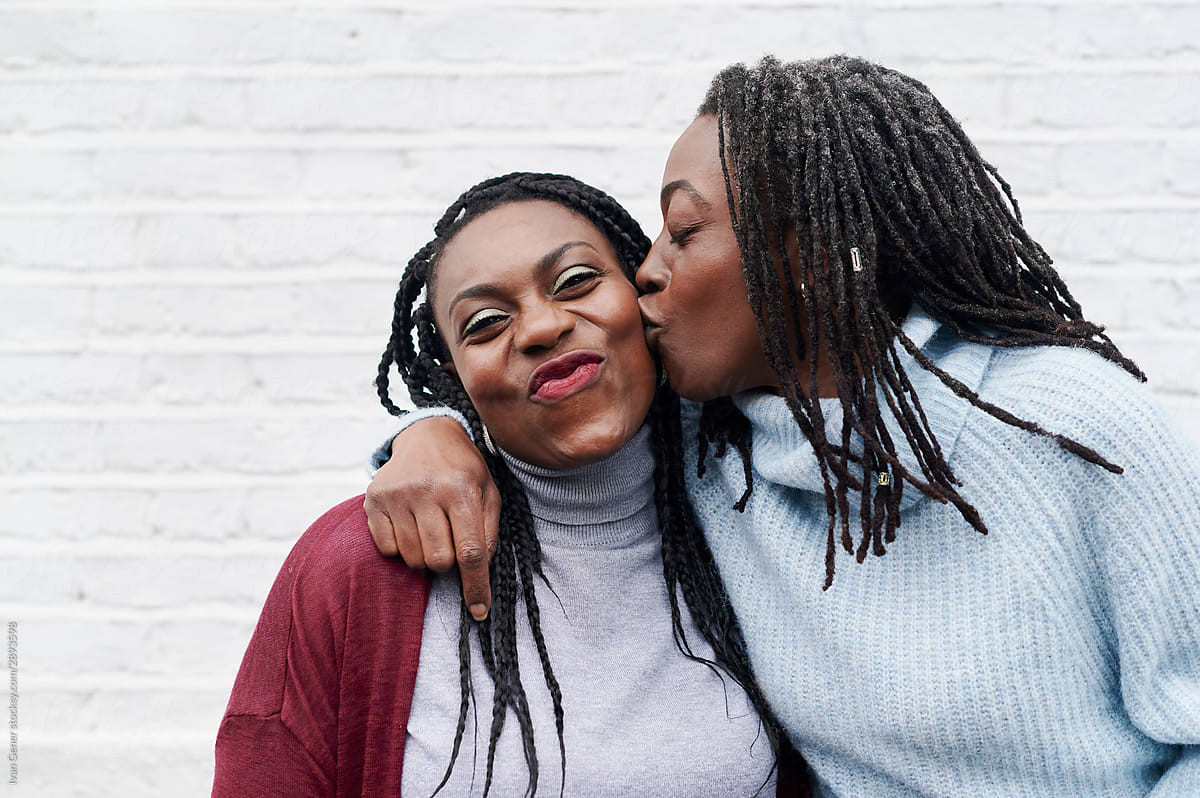 Woman Kissing Her Sister On The Cheek By Ivan Gener Arm Around Sister